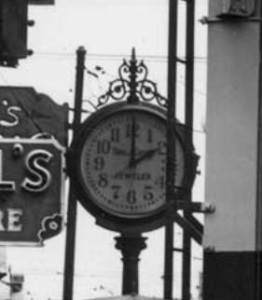 Zoom on Thomas Carrolls' clock at 323 Pike St. 