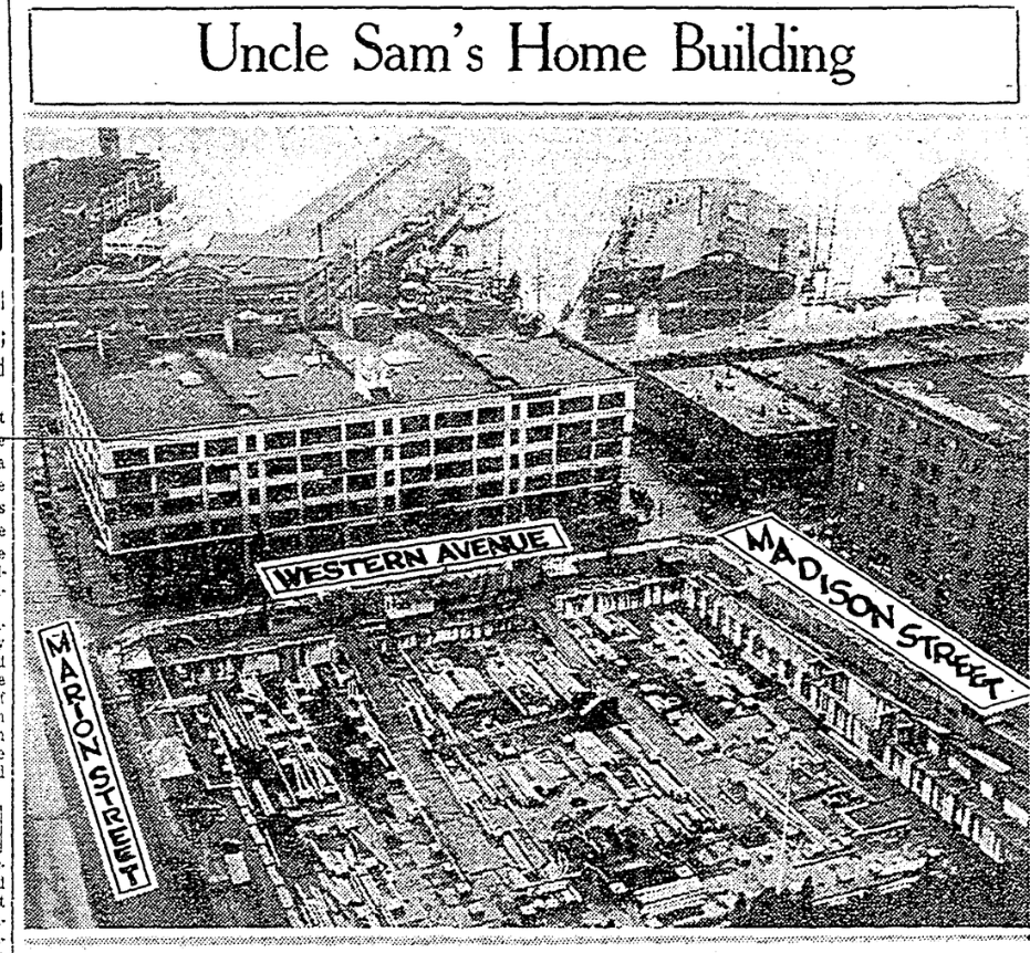 Newspaper clipping showing photograph of construction site. Material fills a block that has no building yet, where the Rainier-Grand Hotel used to be. Streets are labeled Madison Street, Western Avenue, and Marion Street. Post Street no longer bisects the block. The photo is titled "Uncle Sam's Home Building"