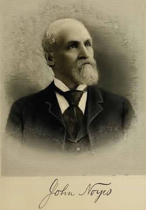 John Noyes, balding with long white beard. He's dressed in suit and tie fitting his wealthy status in 1901.